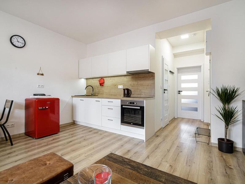 Kitchen with red retro fridge and dining table