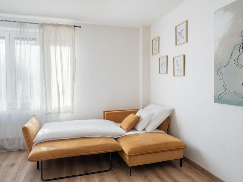 Bedroom with daybed and tall windows